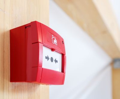 Holzbauoffensive Hessen - Wohnungswirtschaft - Brandschutz Ein Feuermelder an einem Holzbalken